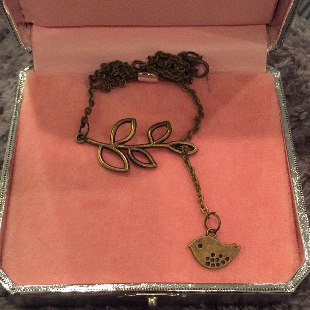 Bird hanging off leaf necklace