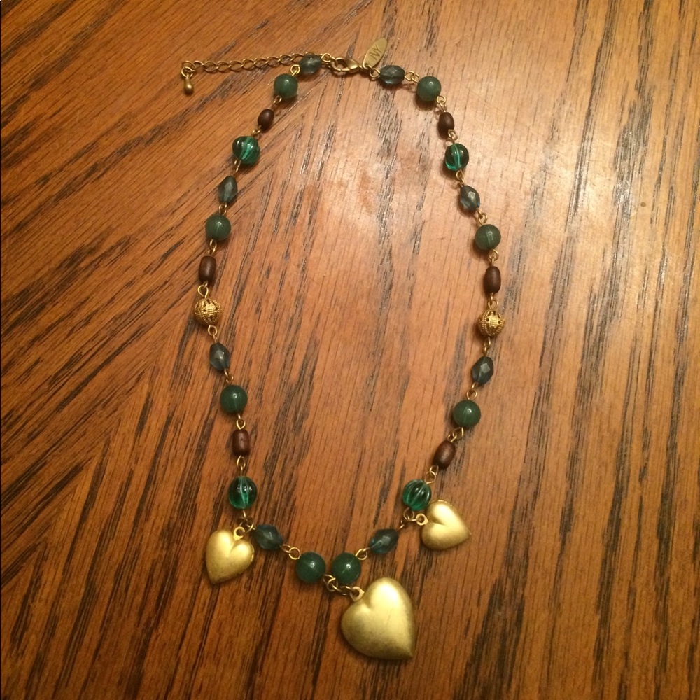 Beaded necklace with gold, heart-shaped lockets.