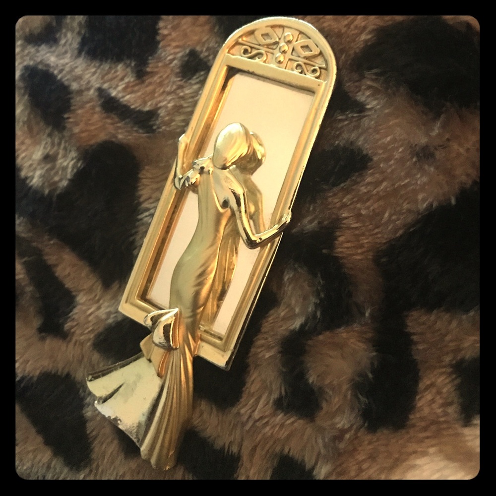 A.J.C. Signed gold-tone “lady in the mirror”brooch