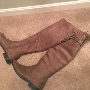 Tan knee-high boots, lace back.