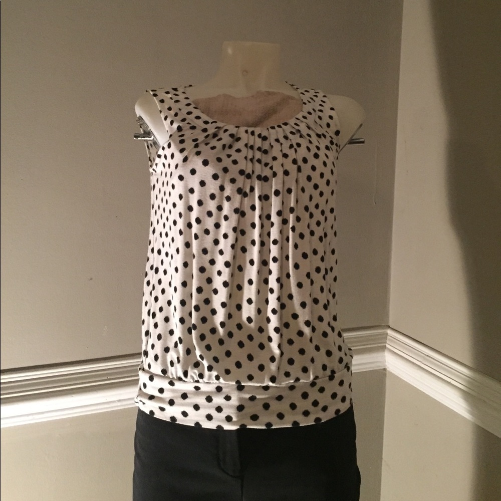 White and black polkadotted shirt.