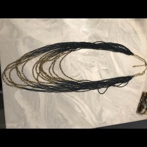 NWOT long gold and charcoal layered necklace.
