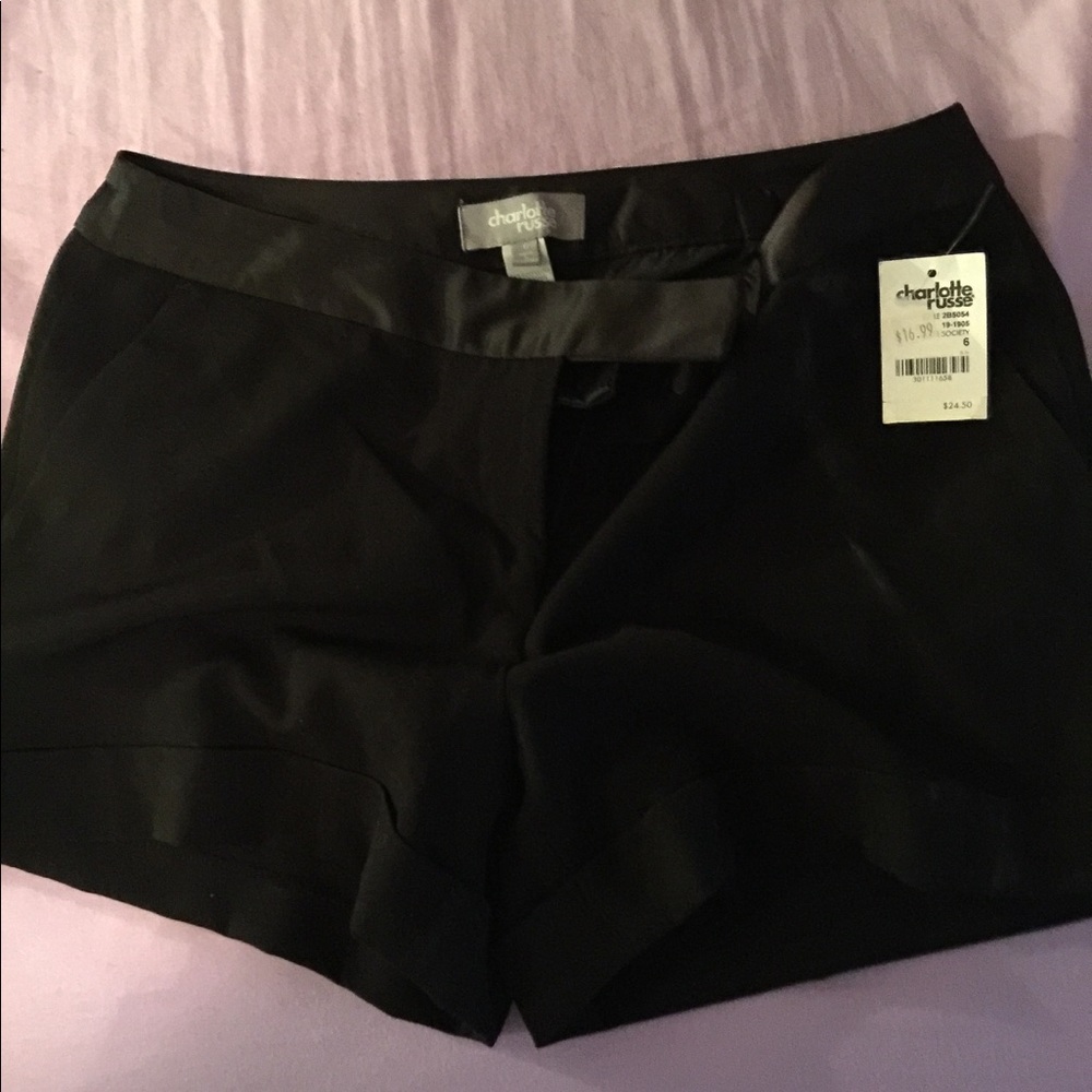 Satiny black shorts.