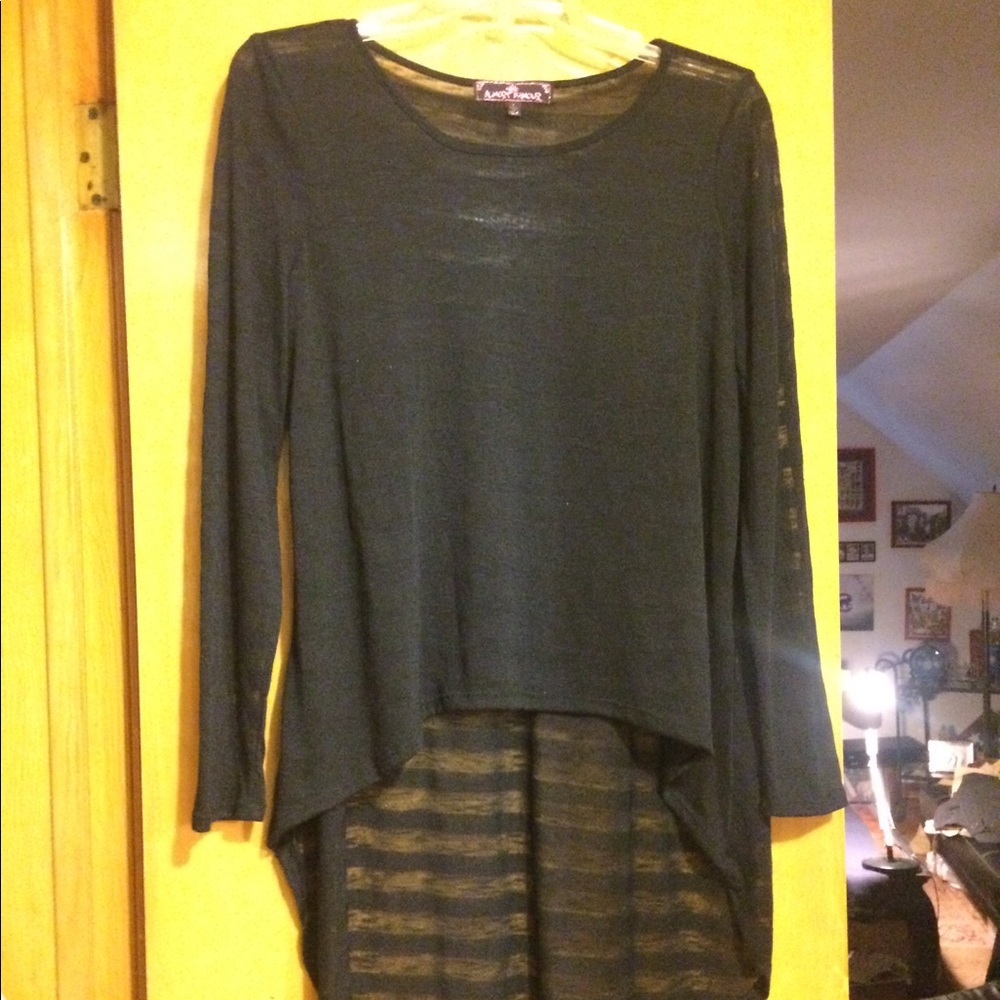 Long sleeved black on black top. Longer in back