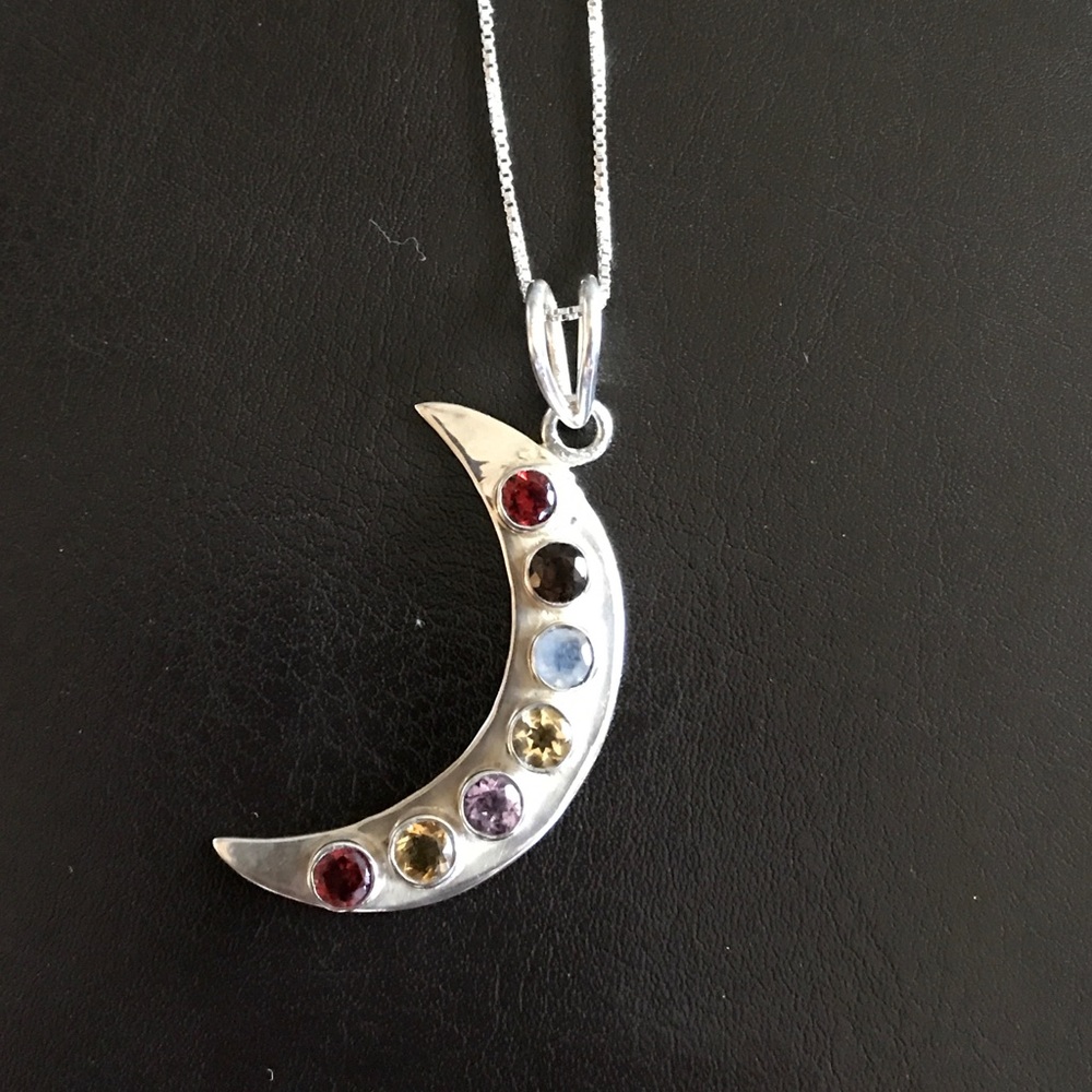 Silver crescent moon and silver chain necklace.