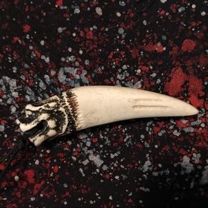 Hand carved tree sap tooth pendant