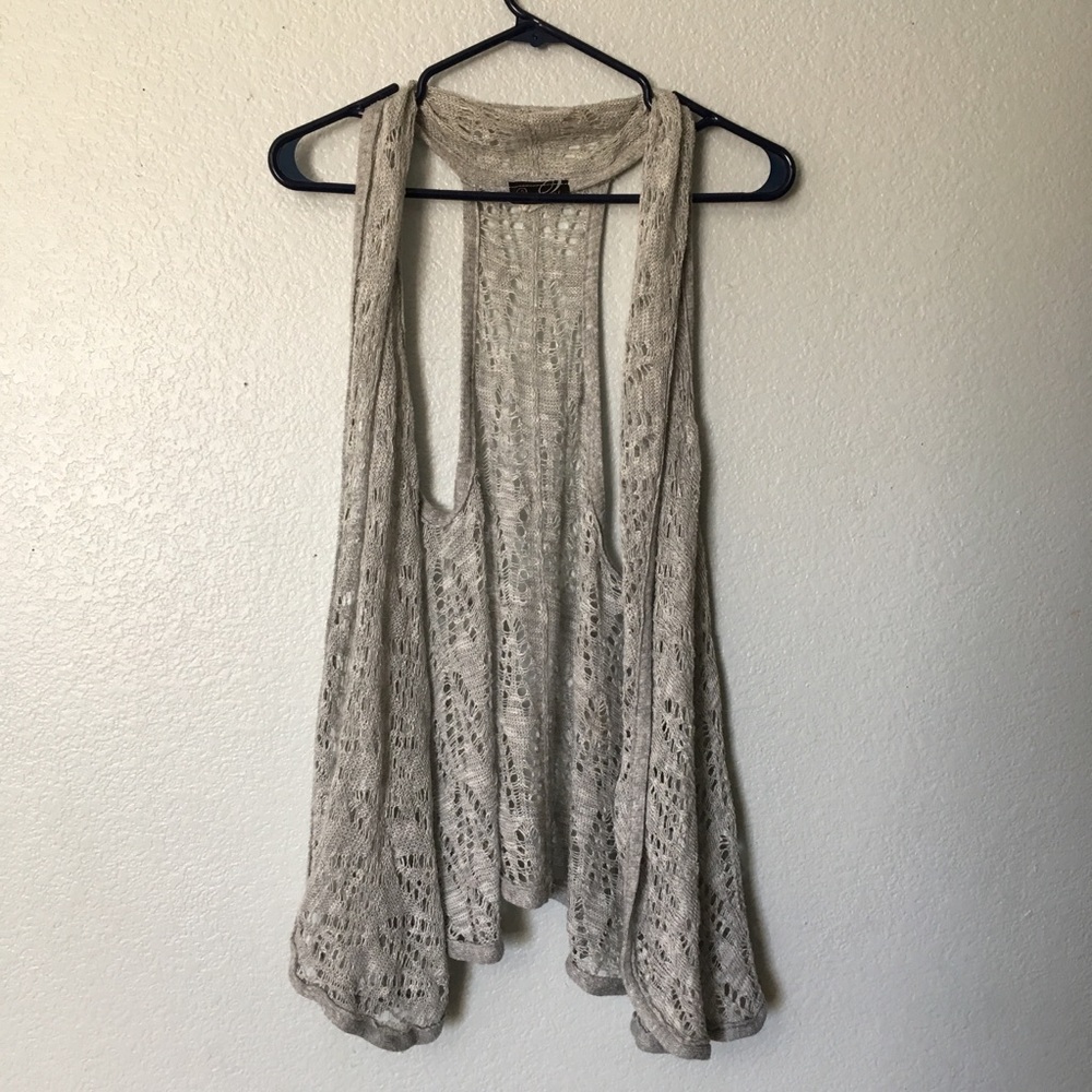 Grey sleeveless cardigan.