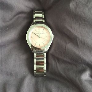 Stainless steel watch with blush pink face.
