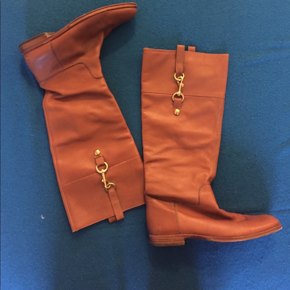 Brown coach boots with gold buckles