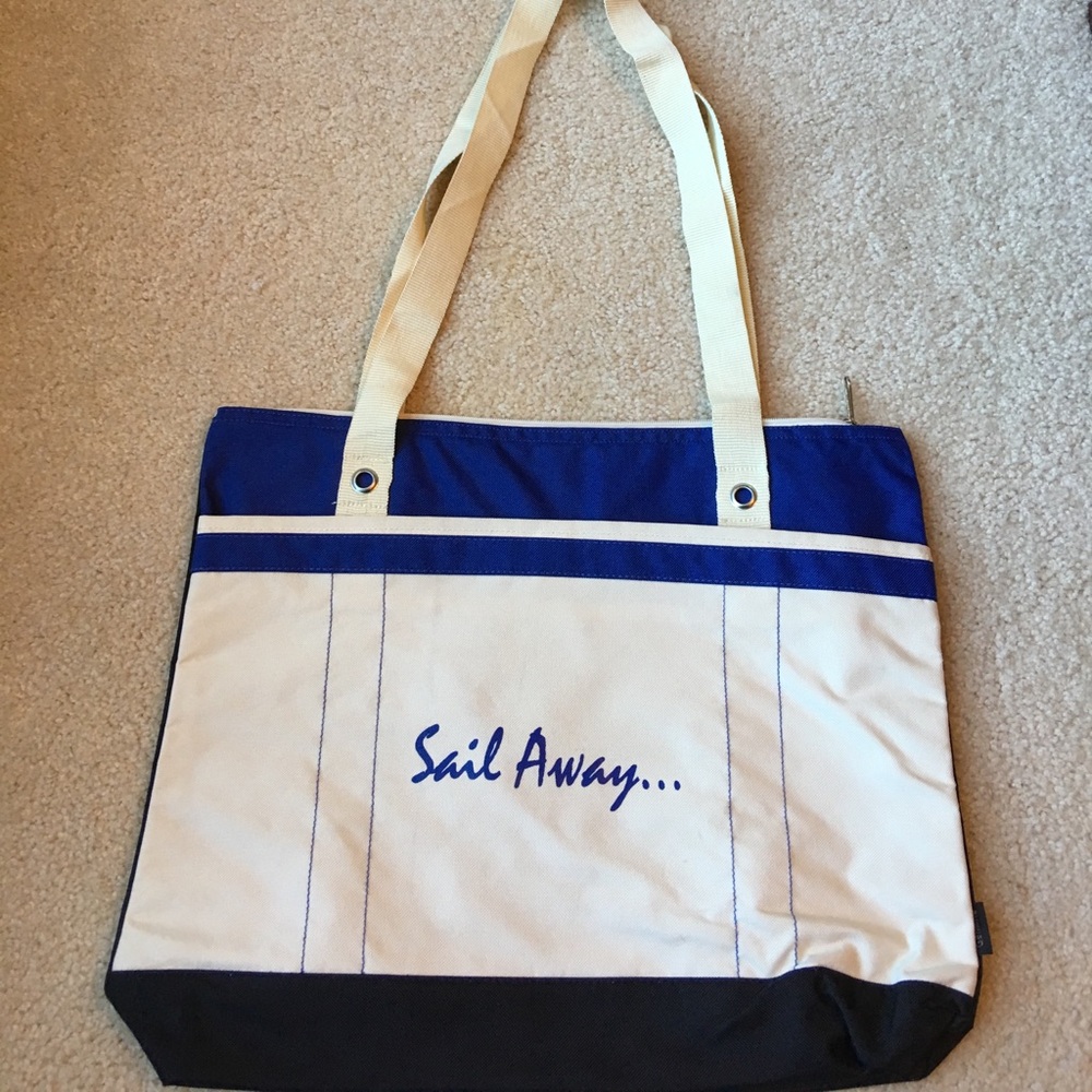 Canvas tote with woven straps, zips closed, pocket