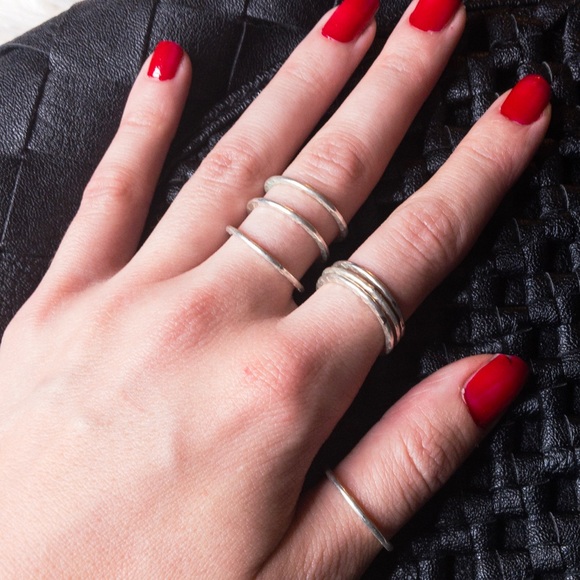 Jewelry - Stack of 7 small silver tone rings.