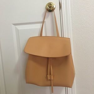 Beige color handle/crossbody handbag.