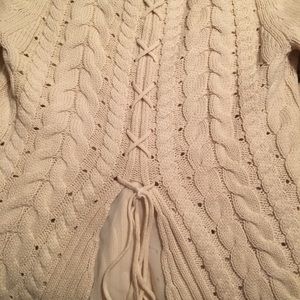 Cable knit sweater with cute back detail.