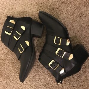 Black booties with gold buckles.