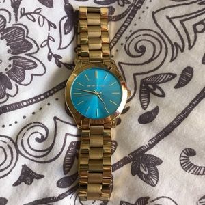 gold michael kors watch with blue face