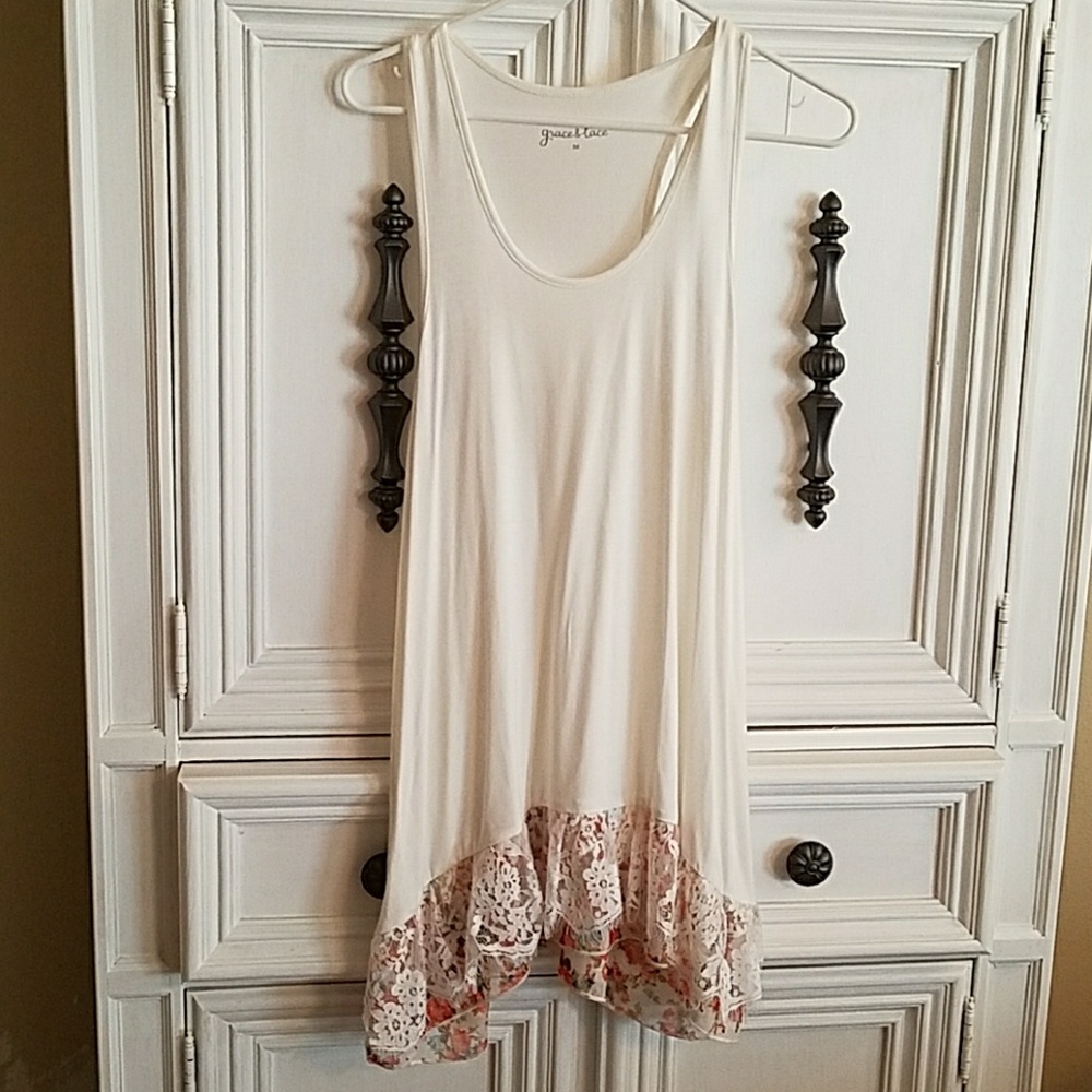Cream colored tank with lace/floral on bottom