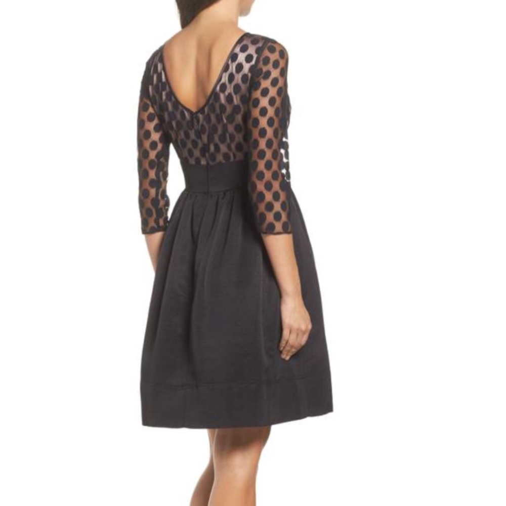 Black cocktail dress with dot design on bottice
