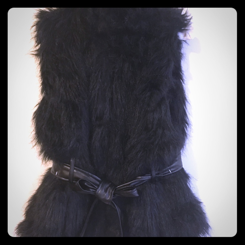 Black, fluffy faux fur vest. Meow!