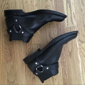 Saint Laurent black leather harness boots.