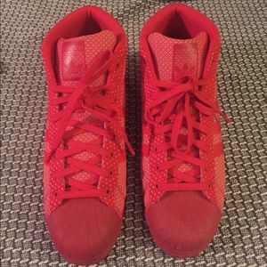 Red Adidas high-top Superstars