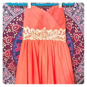 a strapless pink cross back dress with embroidery