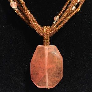 Orange beaded necklace with pendant