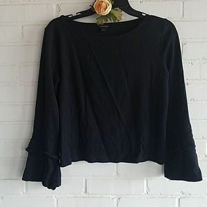 Shorter sweater with bell sleeves
