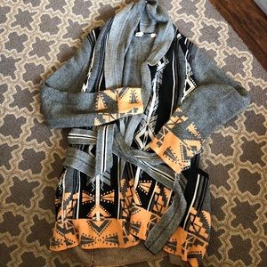 Polyester and wool cardigan sweater.