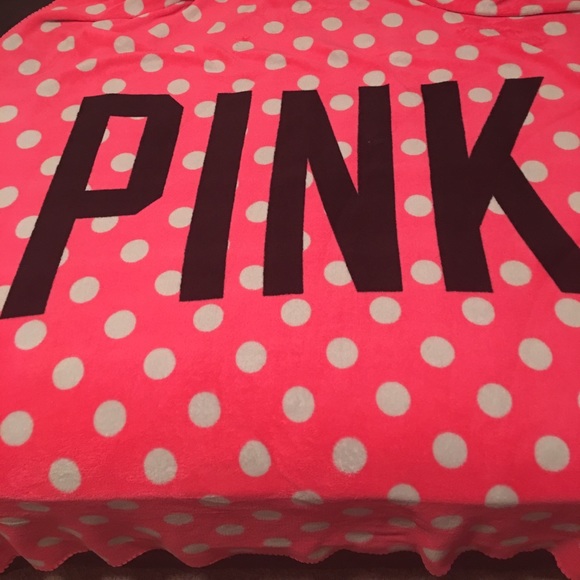 pink blanket with white polka dots
