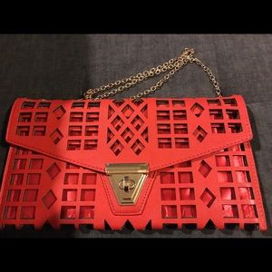 Red  ornate clutch with gold chain strap