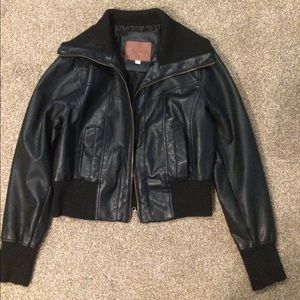 A leather Jacket with a soft material part of it