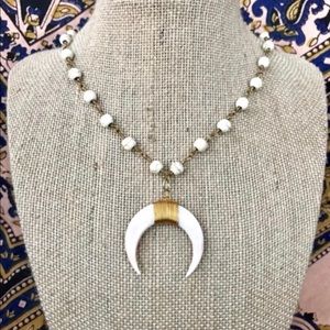 White beaded necklace with crescent horn