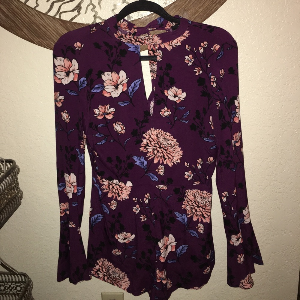 Brand new with tags long sleeve romper.
