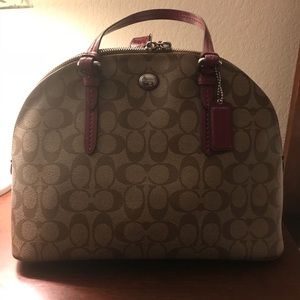 Light brown, pink accented Coach purse