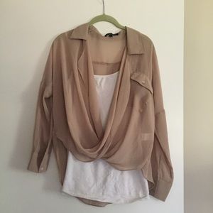 Shear tan blouse with long sleeves.