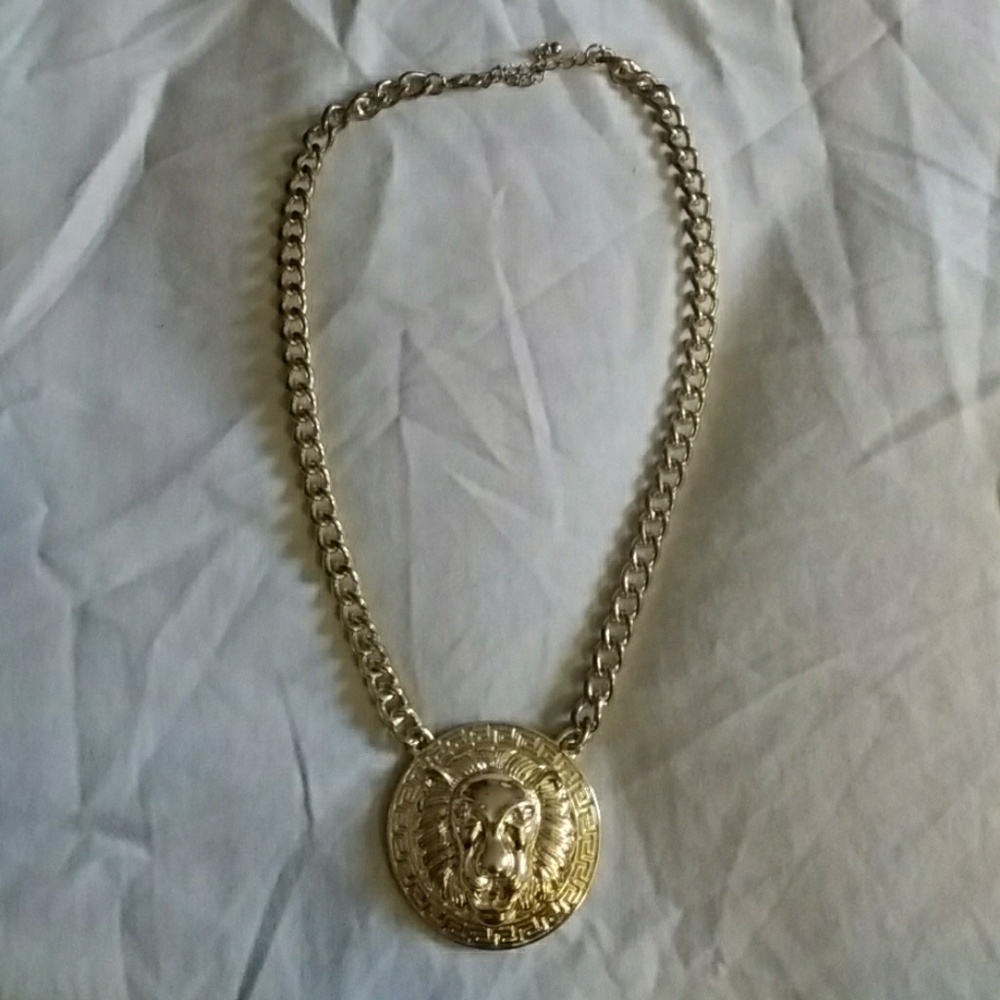 Gold lion face necklace