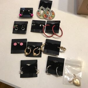 Assorted earrings and a locket broach.