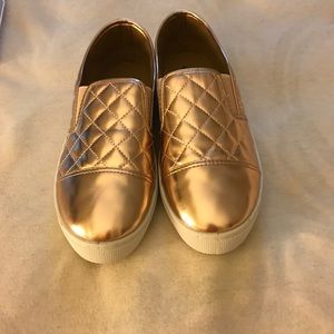 Gold metallic slip on sneakers. Never worn.