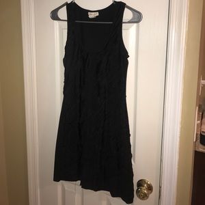 little black dress hugs body has a ruffled front