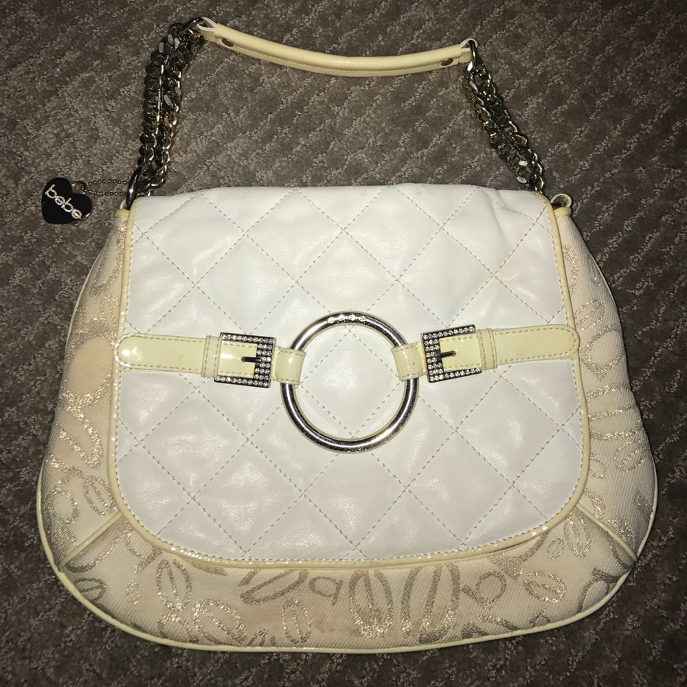 White buckle BeBe purse with gold tossed logo