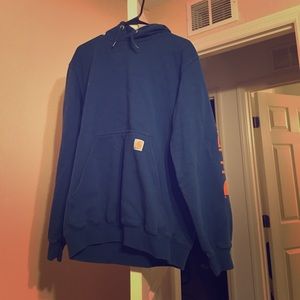 Orange and blue carhartt hoodie. It is a medium