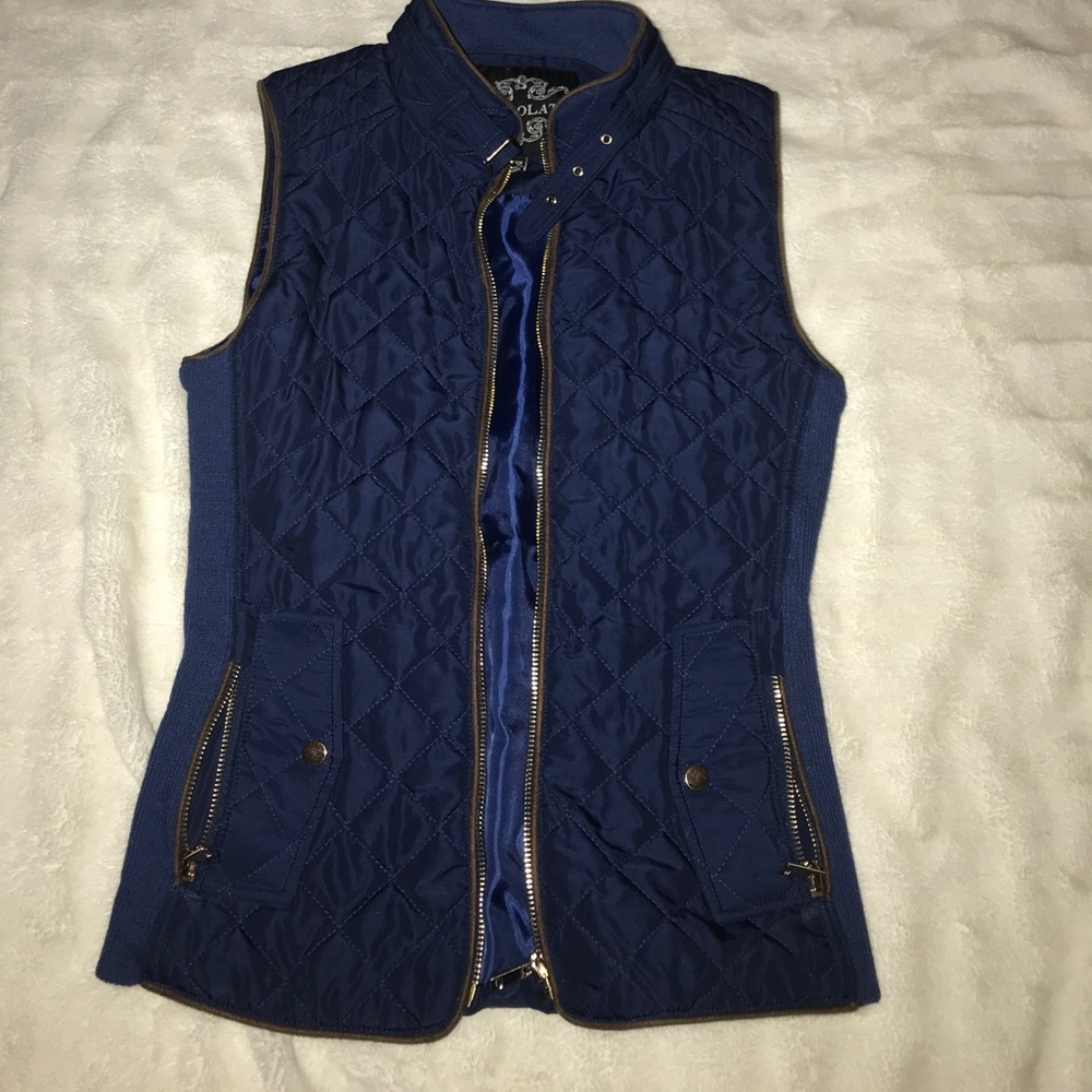 Blue quilted vest with brown piping, gold zippers