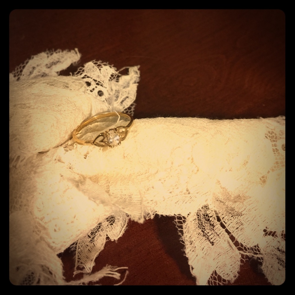 Gold ring, white stone.