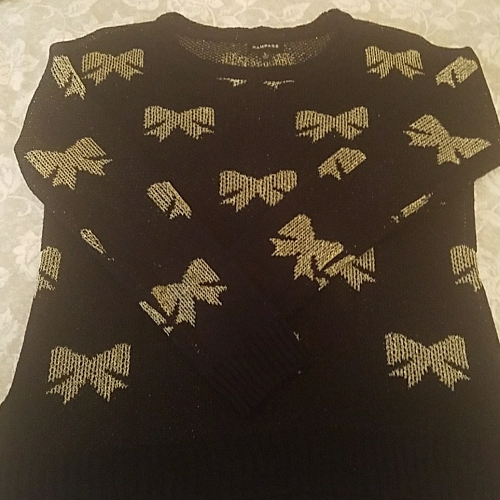 Black sweater with gold bowties