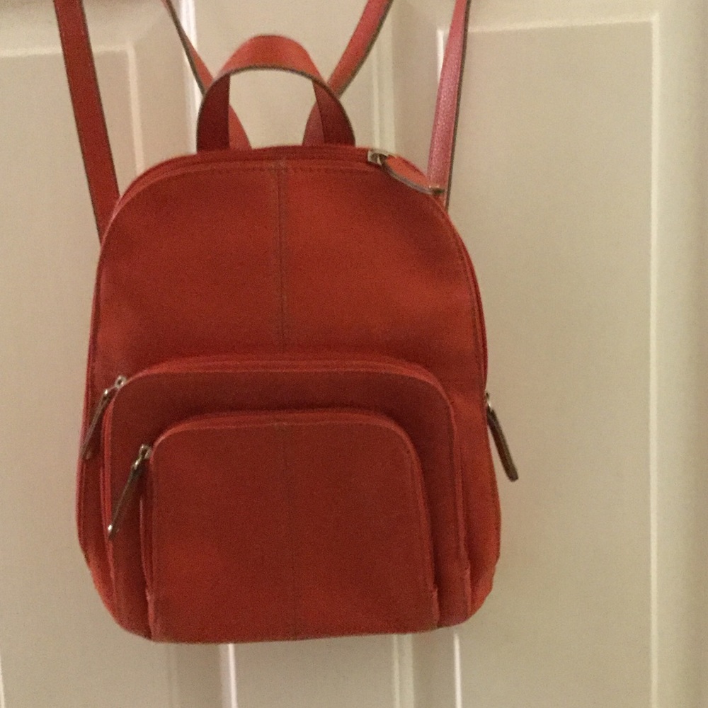 Orange leather backpack purse.