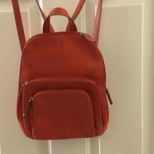Orange leather backpack purse.