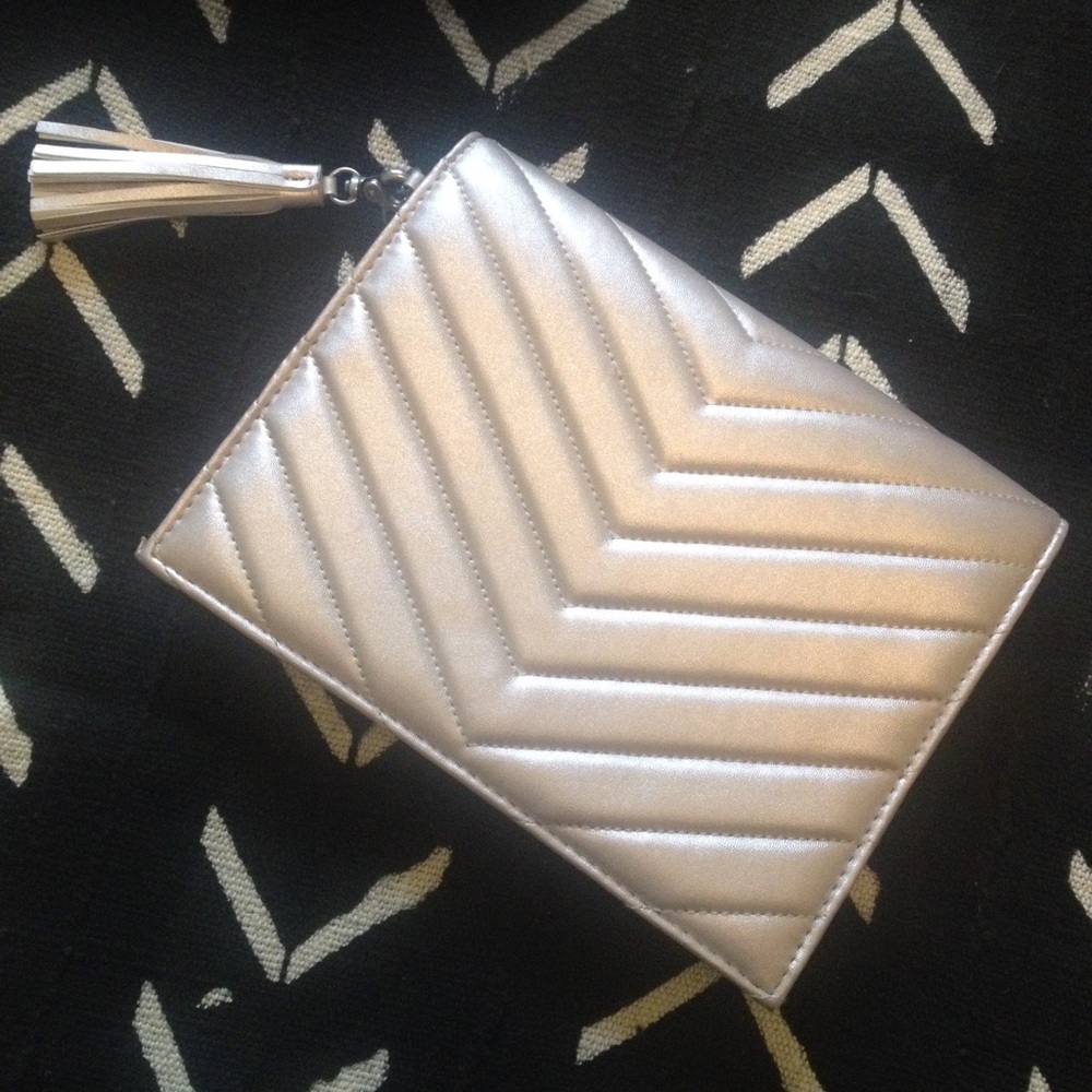 Neiman Marcus faux leather silver clutch w/ tassel