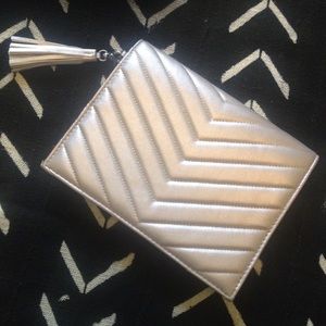 Neiman Marcus faux leather silver clutch w/ tassel