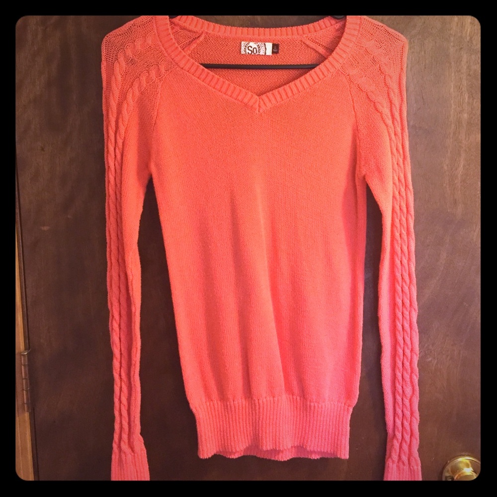 Small salmon pink sweater.