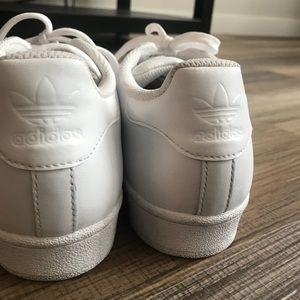 All white Adidas Superstars